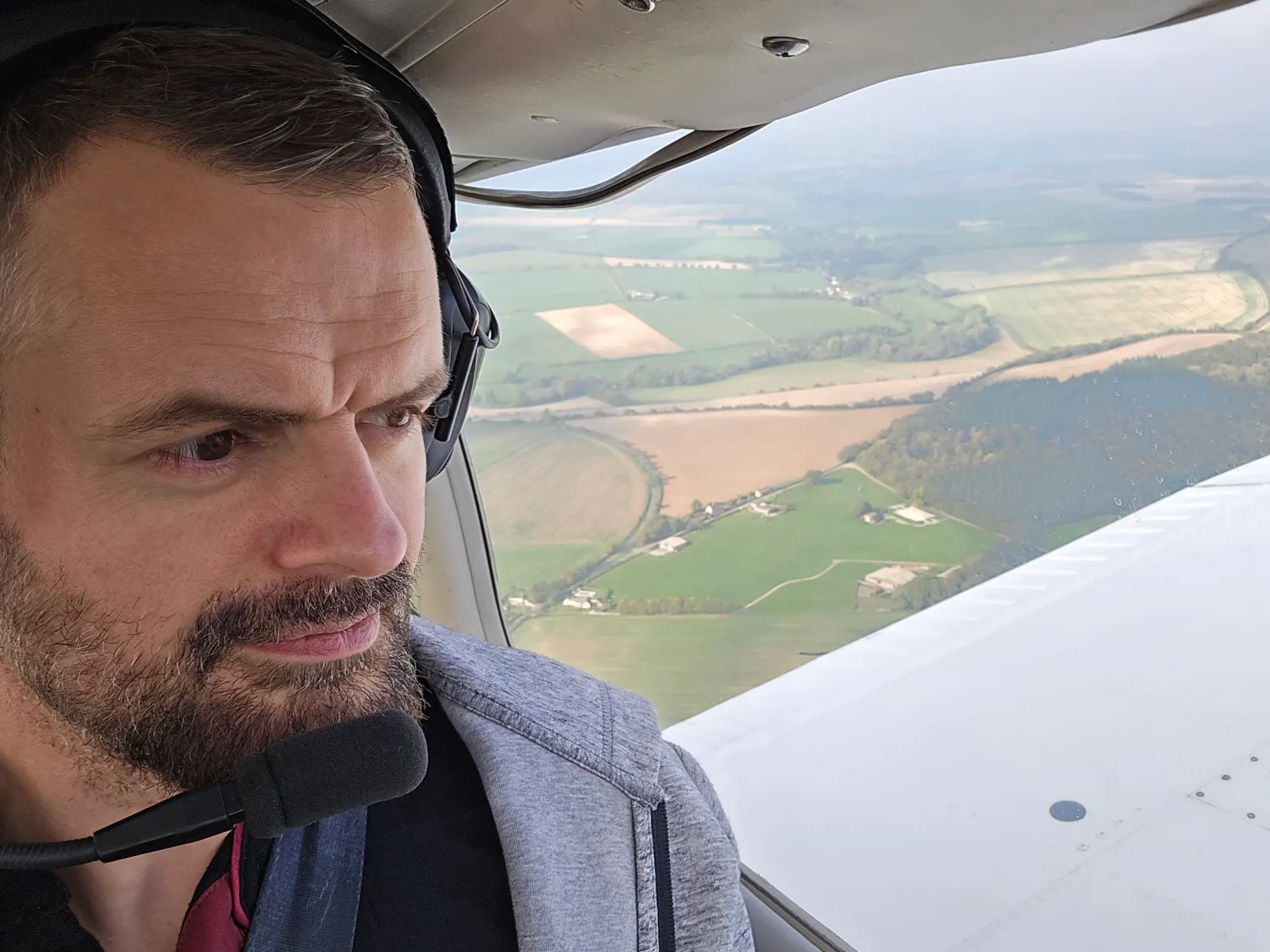 Greg flying a Piper PA-28 with a headset on