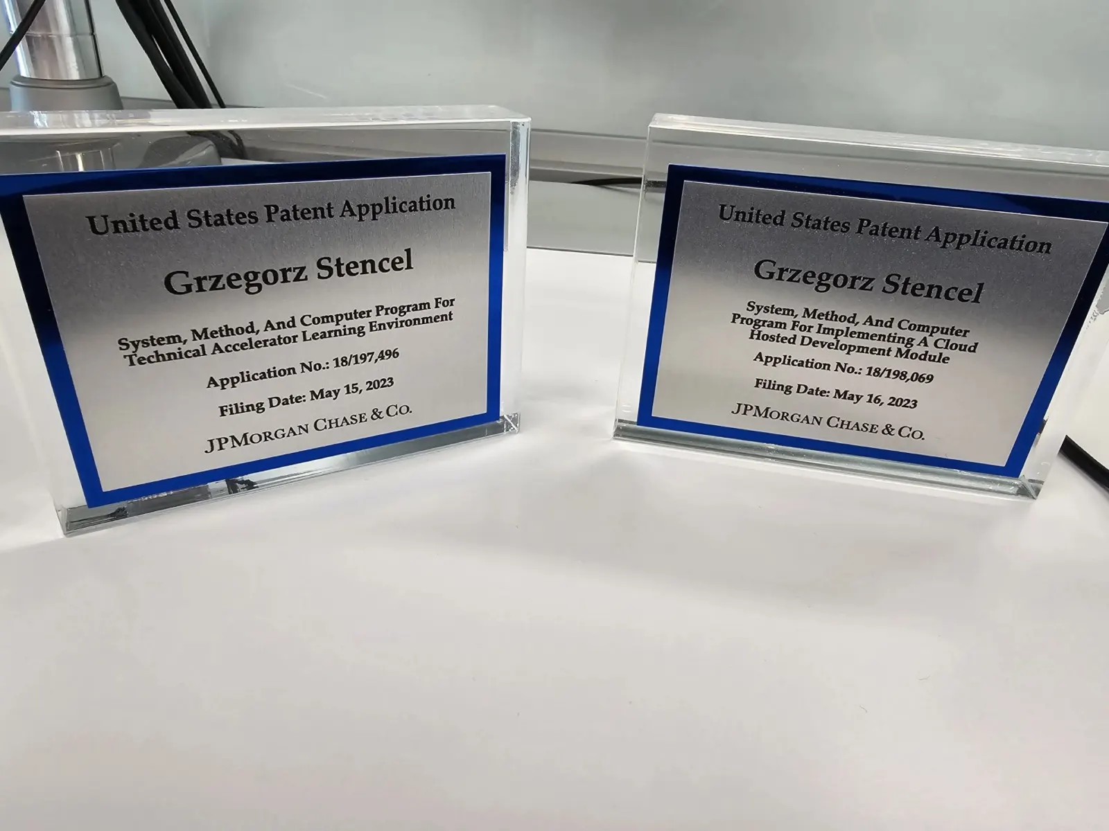 Two framed US patent applications naming Grzegorz Stencel