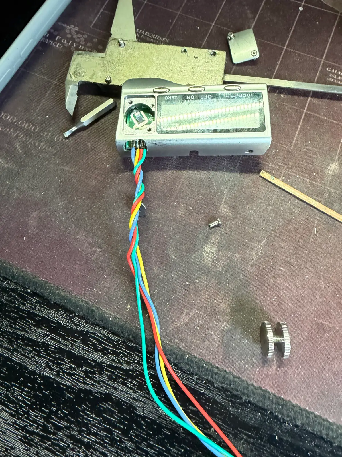 A hand-soldered circuit board with ribbon wiring