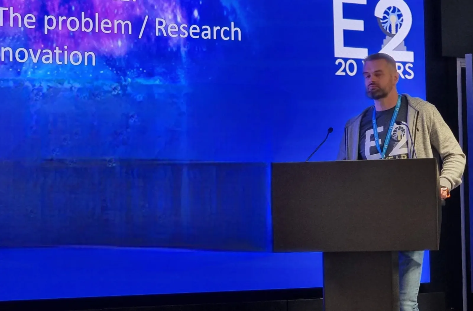 Greg speaking on stage at a conference